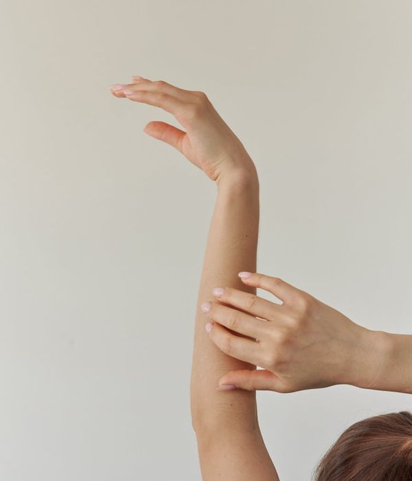Woman in a graceful yoga pose with lavender light accents.